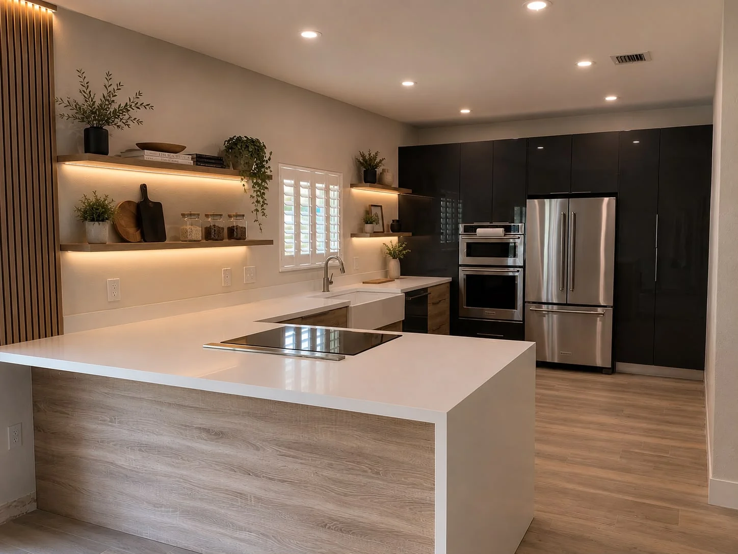 Modern kitchen with black cabinets, white quartz counters, and illuminated open shelving